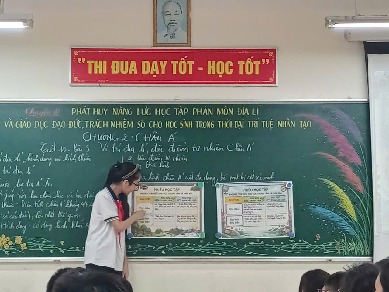 A person standing in front of a chalkboard
Description automatically generated
